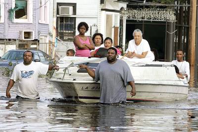 The Hurricane That Changed Everything - Upon the 10th anniversary of Hurricane Katrina, BET.com takes a look back at scenes from the aftermath of the natural disaster. You can watch BET's news special Katrina 10 Years Later: Through Hell in High Water here.  In this photo, people on Canal Street use a boat to get to higher ground as water began to fill the streets. Thousands of people were left homeless after the hurricane.&nbsp;(Photo: Mark Wilson/Getty Images)