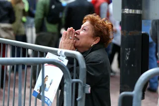 Praying for Peace - A woman kneeled and prayed on Boylston Street. (Photo: John Tlumacki/The Boston Globe via Getty Images)