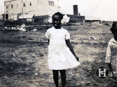 Hidden History - An unidentified African American girl wears a white dress and large white ribbons in her hair.&nbsp; Many residents in Tulsa today say their parents and grandparents never spoke much, if at all about the massacre, leaving the current generation to learn that their ancestors were successful entrepreneurs before their community was attacked.