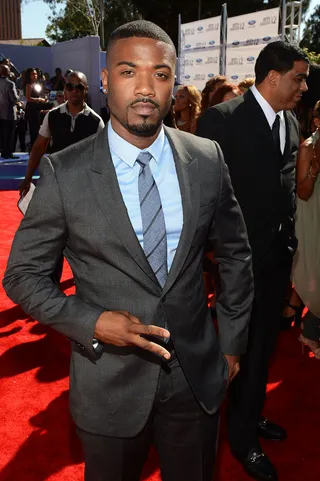 Ray J - A blue button-down and a striped tie are the perfect pieces to freshen up Ray J’s gray suit.(Photo: Mark Davis/Getty Images for BET)