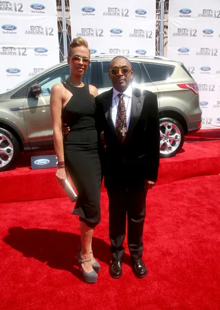 Spike Lee and Tonya Lewis - Spike Lee hit the carpet with his lovely wife, Tonya Lewis, in a slim black suit, paired with a quirky tie and his signature off-kilter shades.&nbsp;(Photo: Maury Phillips/Getty Images For BET)