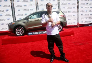 French Montana - Rapper French Montana arrives in a white tee and jeans, plus dozens of diamonds around his neck and wrist.(Photo: Maury Phillips/Getty Images For BET)