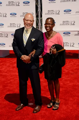 John and Judy Beasley - Composer John Beasley arrives with his wife in a tailored black suit accented with a yellow striped tie.(Photo: Jason Merritt/Getty Images For BET)