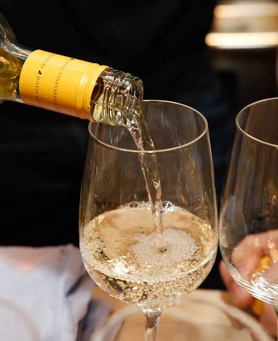 Try a Glass of Wine - Did you know that a 5 oz. glass of wine has only 110-130 calories? Slash even more calories by asking for a wine spritzer — which is wine (red or white) with sparkling water and ice.  (Photo: Amy Sussman/Getty Images for JUSTIN Vineyards &amp; Winery)