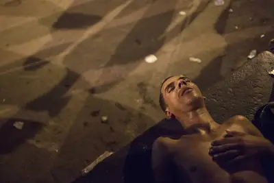 Addicts Lay on the Ground - After midnight, drug addicts lie on the sidewalks of Jacarezinho. Police stand by watching the grim scene.&nbsp;(Photo: AP Photo/Felipe Dana)