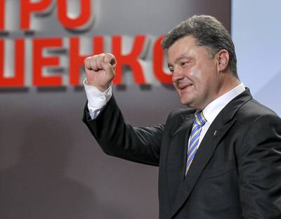 A New President - Billionaire and candy tycoon Petro Poroshenko declared victory by a landslide with 54 percent of the votes in the Ukraine presidential elections on May 25. An ongoing bloody assault on pro-Russian rebels by Ukrainian aircraft and paratroopers soon followed. More than 50 separatists were killed, posing a major challenge to President Vladimir Putin.(Photo: AP Photo/Mykola Lazarenko, Pool)
