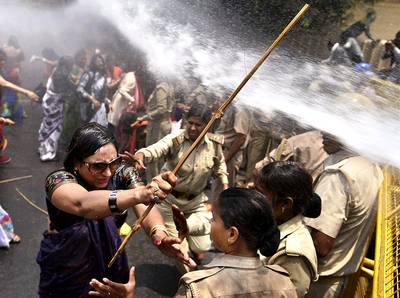 India Protesters Hosed Down - Hundreds of women protesting the sexual assault of women in the Northern Indian state of Uttar Pradeshwere were hosed down by police using water cannons. The women were protesting a recent incident in which two teenagers were gang-raped and found hanging from a tree.&nbsp;&nbsp;(Photo: AP Photo)