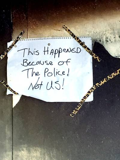 They also left a message. - &quot;This happened because of the police,&quot; reads a note left in what once was the CVS's doorway. (Photo: Joyce Jones/BET)