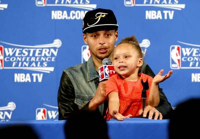 Steph Curry and Riley - We're pretty sure this little will one day be a reporter, mayor or some sort of public figure; she's got chops.  &nbsp;(Photo: Monica M. Davey via Twitter)