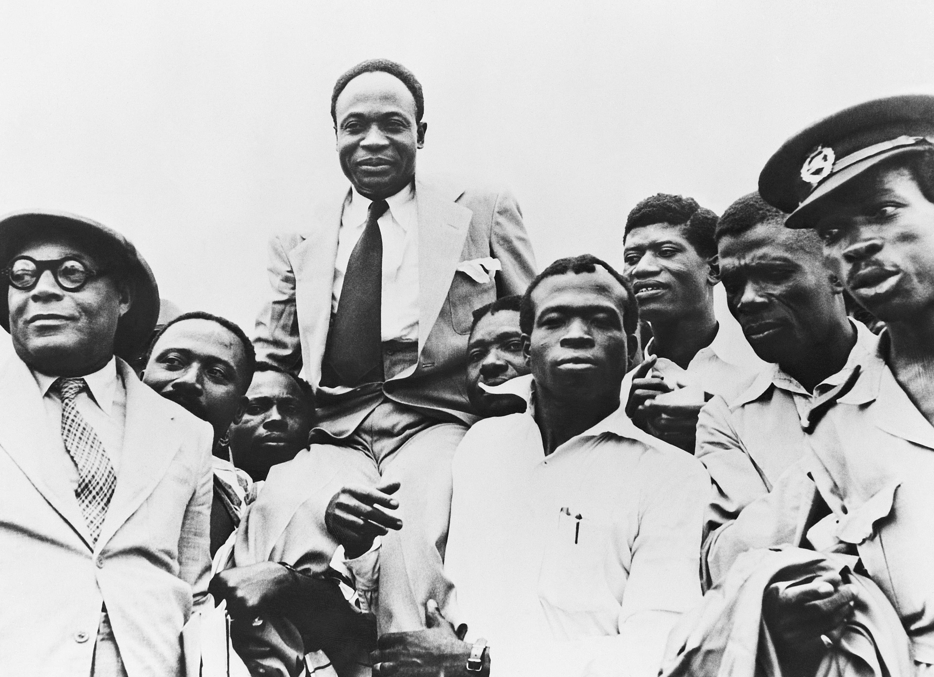 Government officials carry Prime Minister Kwame Nkrumah on their shoulders after Ghana obtains its independence from Great Britain.