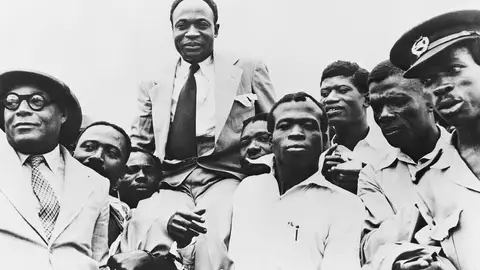 Government officials carry Prime Minister Kwame Nkrumah on their shoulders after Ghana obtains its independence from Great Britain.