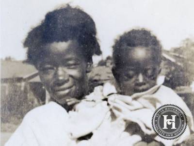 Staying Close - An African American girl holding her younger sibling in a photograph taken in the Greenwood District following the massacre.