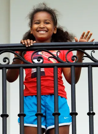 The New Normal - Sasha waves to her father from the Truman Balcony upon his return from a trip to Arizona and New Mexico in May 2009. (Photo: Win McNamee/Getty Images)