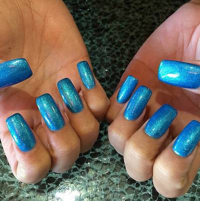 Amber Rose - Oh, you didn’t get the memo? This season’s hottest trend is matching your nails to your ‘do à la Amber’s new aquamarine buzz cut and glittery, long tips.  (Photo: Amber Rose via Instagram)