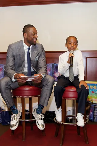 Teach the Babies - Miami Heat veteran&nbsp;Dwyane Wade&nbsp;is all smiles listening to a young member of his Wade's World Foundation dinner at Chicago Cut Steakhouse in Chicago. (Photo: Jeff Schear/Getty Images for Michigan Avenue Magazine)
