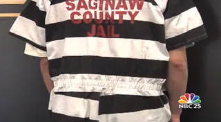 Prison Changes Orange Inmate Uniform to Black and White - A Michigan prison changed their orange uniforms to black and white after they noticed civilians wearing orange suits with Saginaw County Jail written on the back. The County sheriff believes it is influenced by the popularity of the Netflix show&nbsp;Orange Is the New Black.&nbsp;   (Photo: WEYI-TV NBC 25 News)