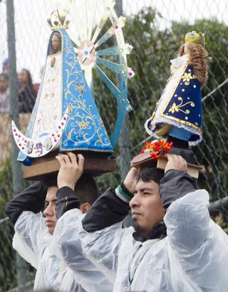 Above It All - Argentine pilgrims raised statues of the Virgin Mary above their heads while they listened to the pope’s address in Varginha.(Photo: AP Photo/Domenico Stinellis)