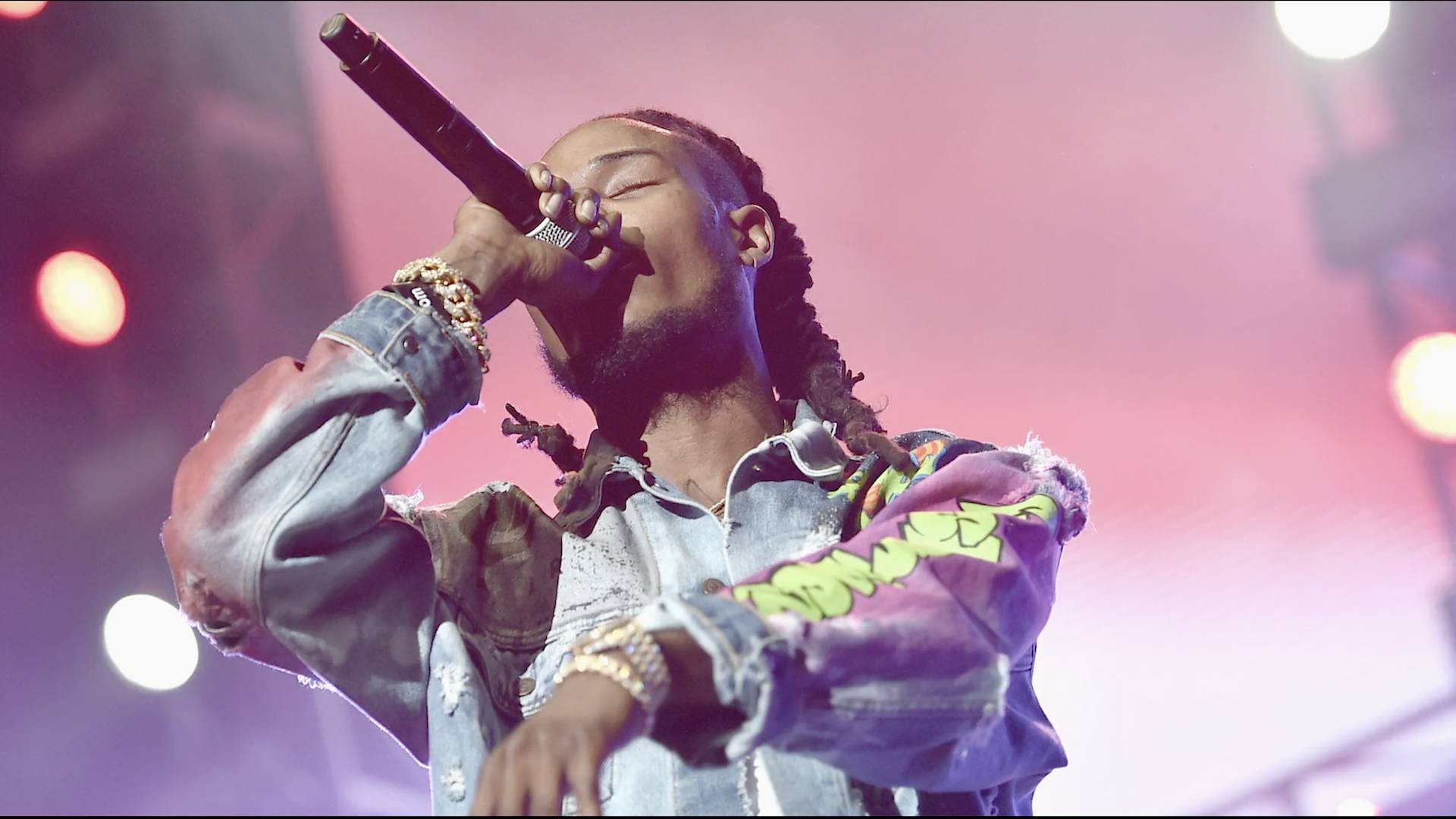 Rapper Future on stage performing in a multi-colored shirt.