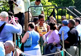 First Lady Fans - First Lady Michelle Obama was crowded by excited attendees when she came down to the lawn with Malia and Sasha to give egg rolling a go. (Photo: Angel Elliott/ BET Digital)