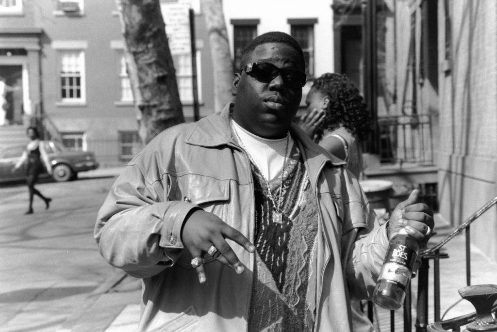 American rapper Biggie Smalls (also known as the Notorious B.I.G., born Christopher Wallace, 1972 - 1997) holds a bottle of St. Ides malt liquor, New York, New York, 1995. (Photo by Adger Cowans/Getty Images)