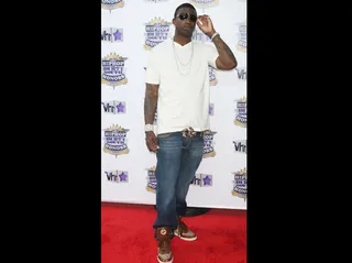 Gucci Mane - Gucci Mane showed his cool in a white v-neck tee and brown Gucci sneakers.&lt;br&gt;&lt;br&gt;(Photo Credit: PictureGroup)