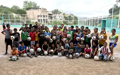 Honduras Kids Aim for Better Life through Soccer - The AP recently spotlighted Honduran native Luis Lopez and his ambitious soccer program to help keep dozens of local girls and boys safe in a country with the highest murder rate in the world. &quot;The field has created a group, comfort, friendship. It gives them a place to belong, something to care about, something they don't want to lose,&quot; Lopez, also known as &quot;Luisito,&quot; told AP. A California-based foundation has sent funds to the program to upgrade the field, purchase equipment and rent travel buses; and while Lopez has gladly used the resources, he also worries that they will attract extortion and threats. &quot;The day that one of these guys decides that something about this project goes against them, he'll come and tell us that it's all over,&quot; Lopez said.(Photo: Esteban Felix/AP Photo)