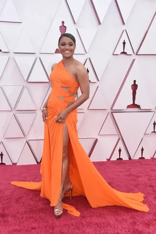 Ariana DeBose looks radiant in an orange Versace gown with Stuart Weitzman shoes. - (Photo: ABC via Getty Images)