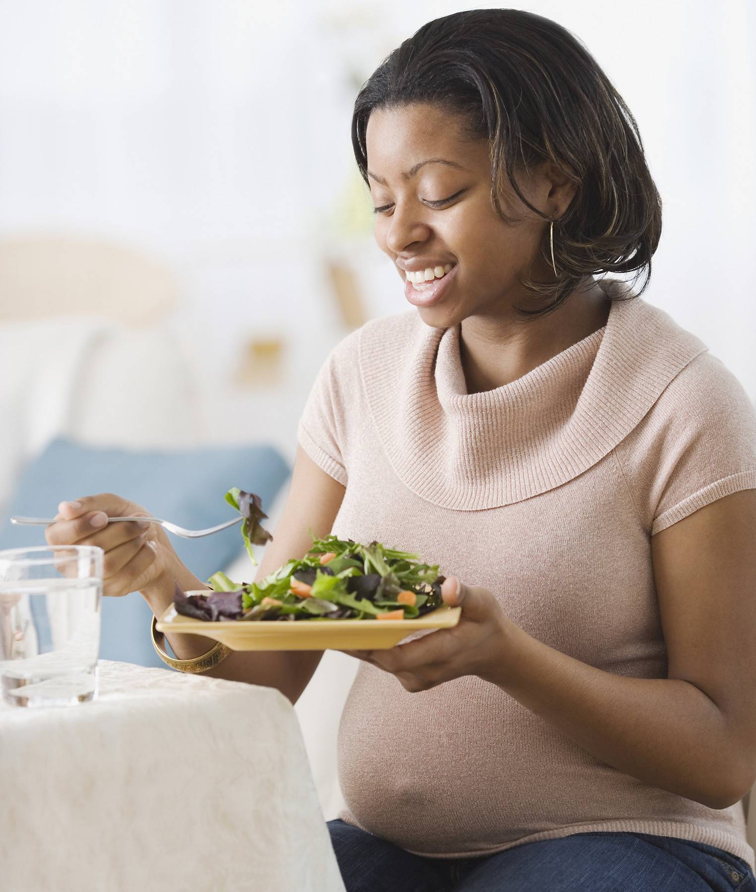 pregnant woman eating salad