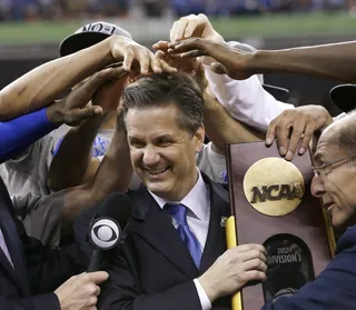 Job Well Done - Kentucky head coach John Calipari celebrates with the team after the win. (Photo: AP Photo/David J. Phillip)