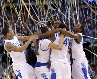Players Rejoice - Kentucky players celebrate their win against Kansas on the court. This year's NCAA champtionship victory is the team's first since 1998. (Photo: AP Photo/David J. Phillip)