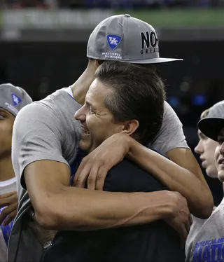 Hug It Out - Emotional Kentucky head coach John Calipari gets a hug from forward Anthony Davis after their team beat Kansas. \r(Photo: AP Photo/David J. Phillip)