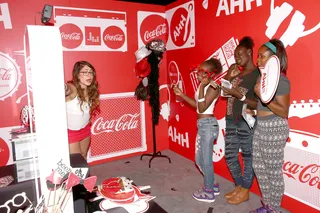 Snapping It Up - Some fans had a moment to try on Coca-Cola themed accessories for some fun pics.(Photo: Rich Polk/BET/Getty Images for BET)