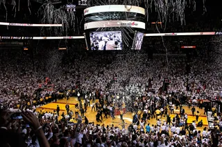The American Airlines Arena Celebrates Heat Win - The American Airlines Arena pours out confetti to celebrate the Miami Heat's victory over the San Antonio Spurs. Fans clapped and jumped in the stands to end the season-long journey with their home team.&nbsp;(Photo: Kevin C. Cox/Getty Images)