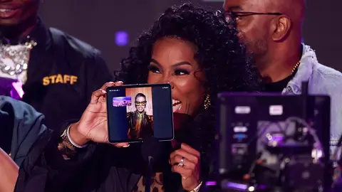 Winner of Best Video Director of the Year Teyana "Spike Tey" Taylor is seen on a smartphone screen held by her mom on stage during the 2023 BET awards at the Microsoft theatre in Los Angeles, June 25, 2023.  