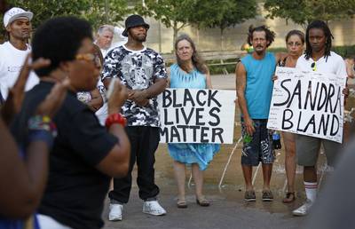 #BlackLivesMatter - An activist known as Olinka Green spoke to community members during a rally Friday, July 17 to bring awareness to Sandra Bland's case.(Photo: Louis DeLuca/The Dallas Morning News via AP)