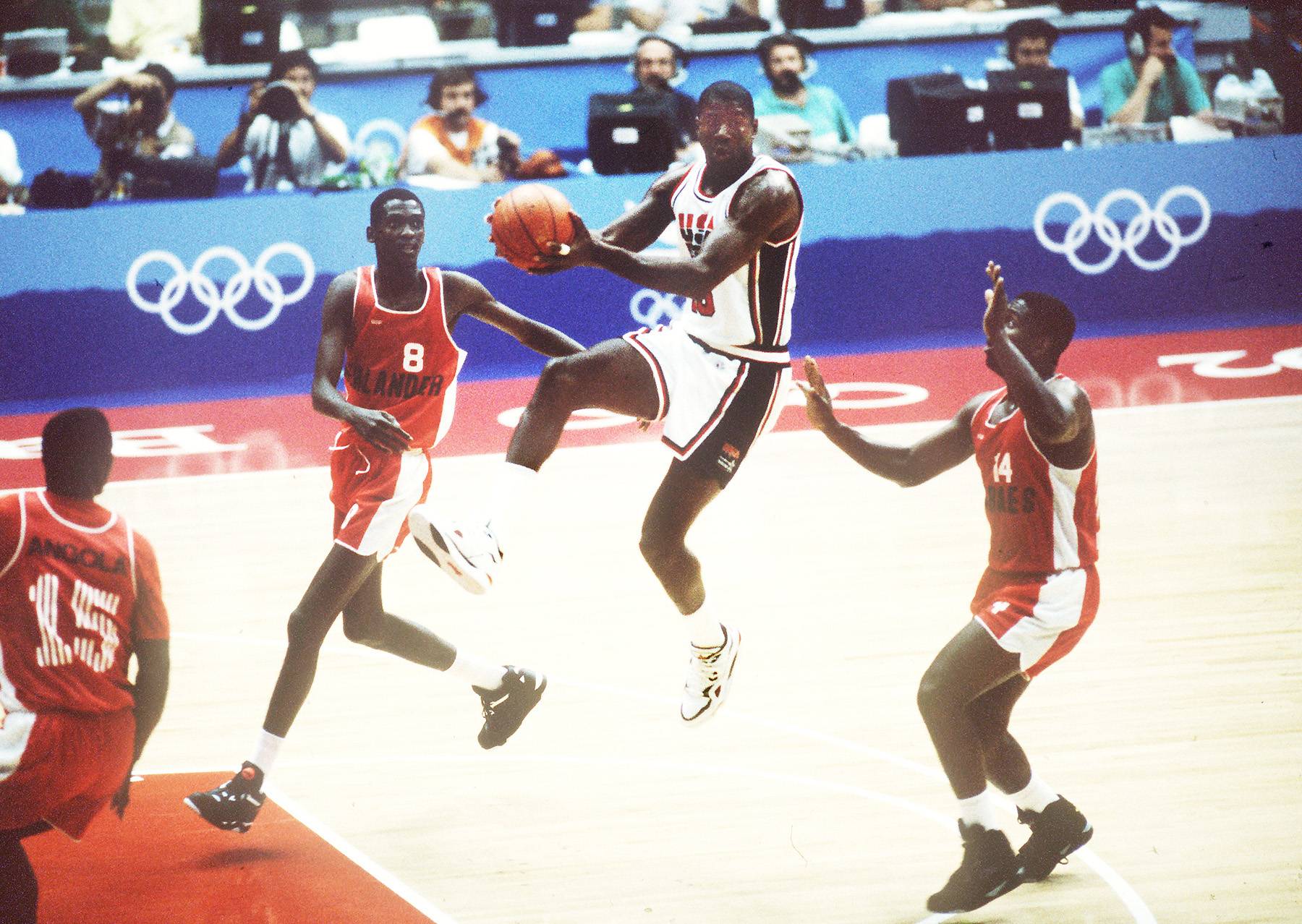 Watch Him Fly - Magic Johnson soars above players of team Angola. (Photo: DPA /LANDOV)
