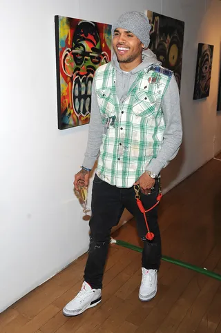 Toy Story - Chris Brown cheeses for the cameras at the Dum English Art Exhibition and Media Event at Opera Gallery in New York City. Brown helped design the Dum English line of toys with Garageworks' Ron English. The exhibit was part of the brand's launch.&nbsp;(Photo: Brad Barket/Getty Images)