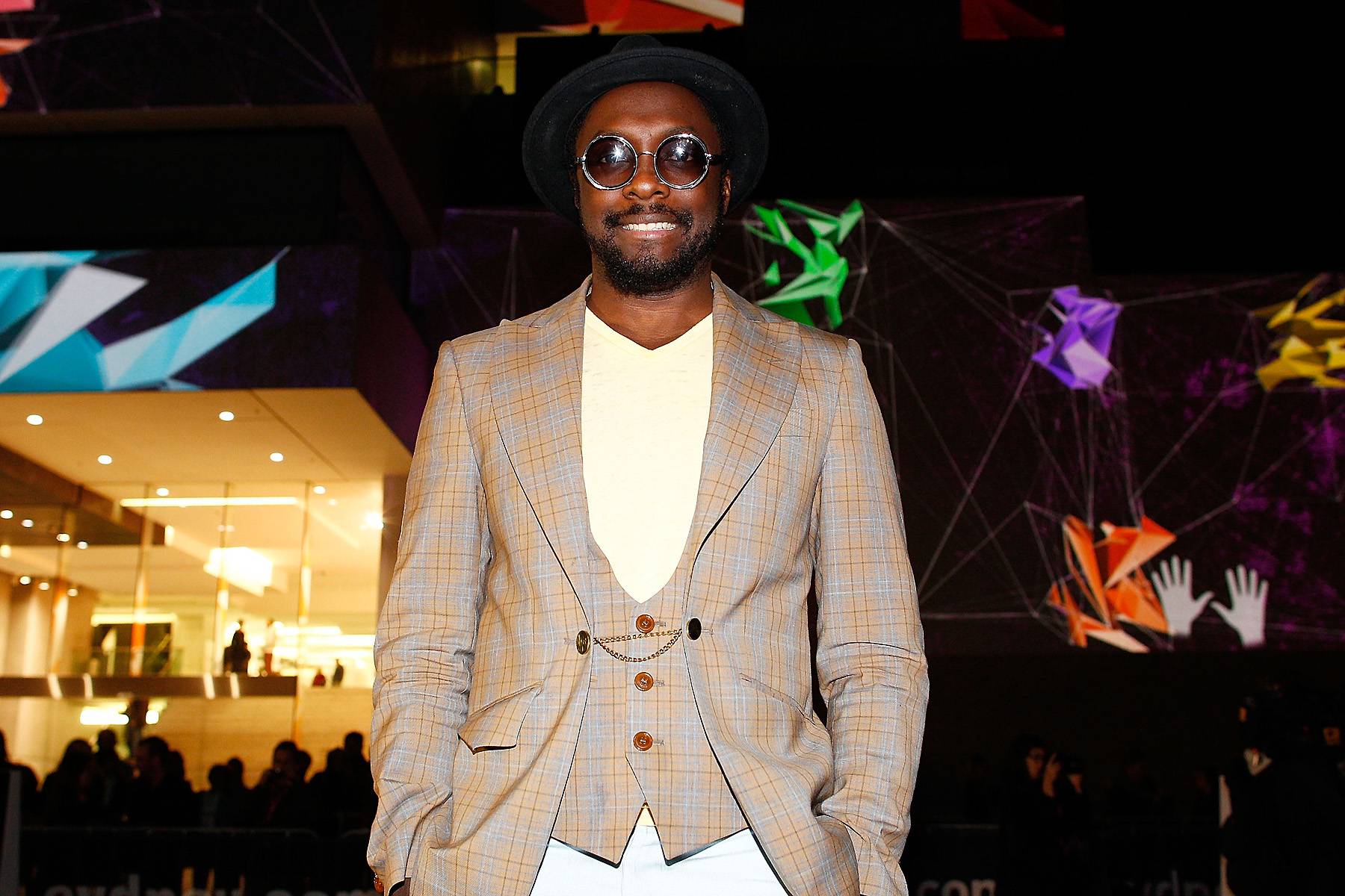 Sir William - Will.i.am poses outside of the Museum of Contemporary Art during Vivid Sydney wearing an Old English plaid sport coat and matching vest in Sydney, Australia. (Photo: Brendon Thorne/Getty Images)
