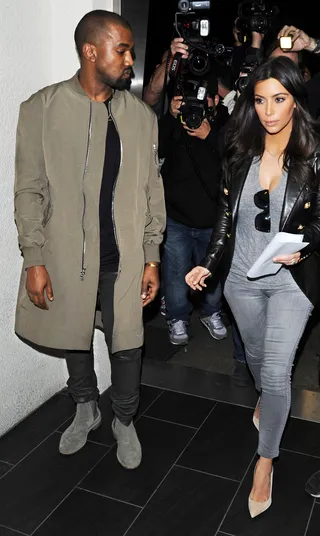 Him and Her - Kanye West and Kim Kardashian wade through a sea of paparazzi at LAX airport in Los Angeles.(Photo: Diabolik / Splash News)