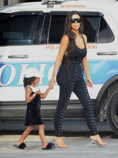 Mommy-and-Me Take Miami - North is owning the velvet dress trend. She's also traded in her signature Dr. Martens for furry sandals. Are you here for her style evolution?(Photo:&nbsp;&nbsp;Splash News)