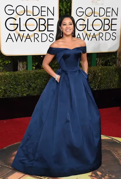 Gina Rodriguez - The Jane the Virgin star is batting a thousand with her awards season looks. This royal blue, floor sweeping gown with portrait neckline fits the evening's classic glamour trend to a T.(Photo: VALERIE MACON/AFP/Getty Images)