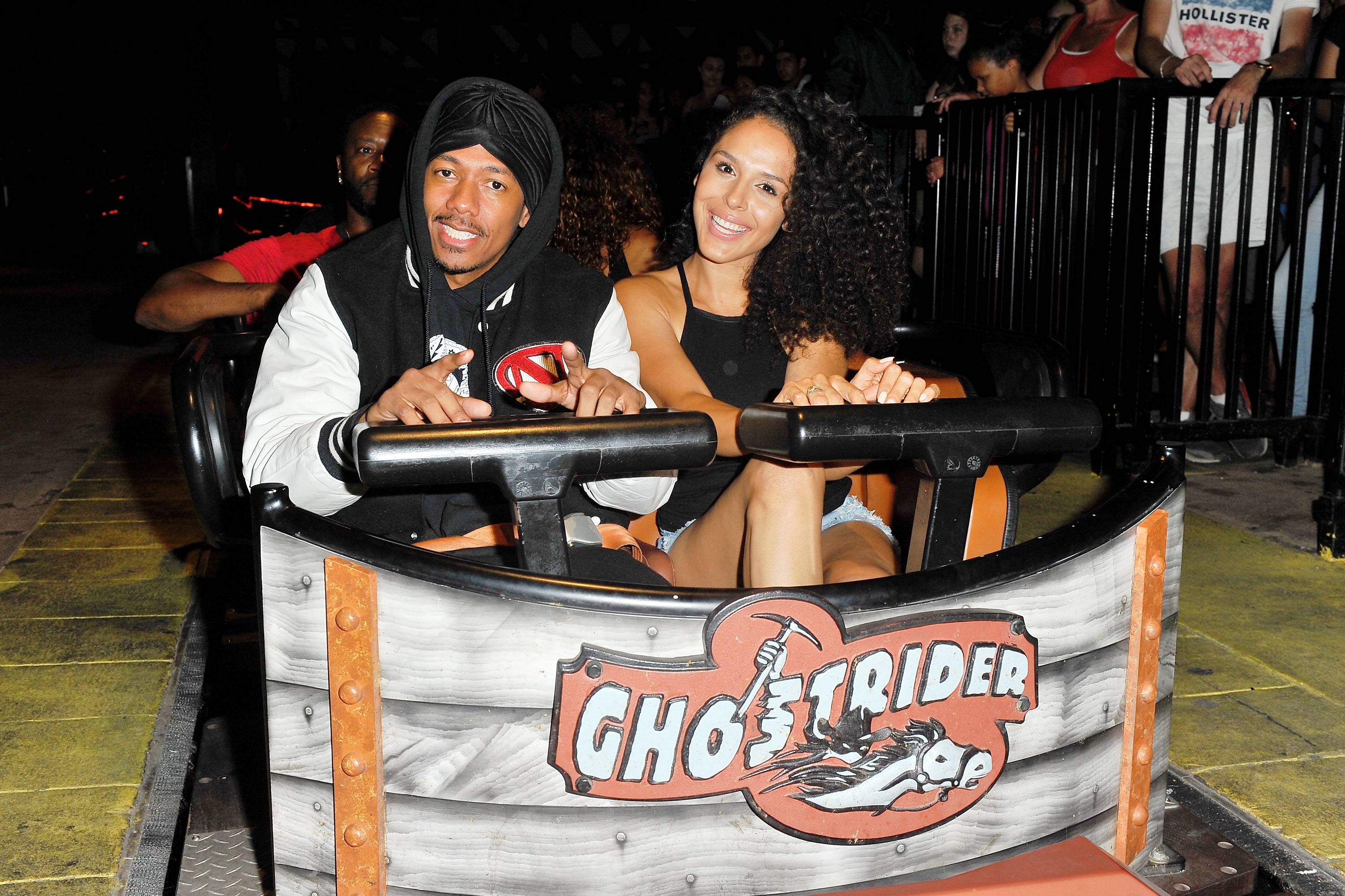 Actor Nick Cannon and Brittany Bell ride 'Ghostrider' at Knott's Berry Farm on September 1, 2017 in Buena Park, California.