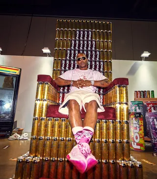 Cam'ron - Cam'ron posted up at the throne wearing a pink collaborative Pizzaslime x Four Loko tee where he posed with fans. (Photo: William Azcona/Four Loko)