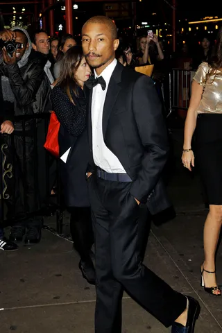 Gala-vanting - Pharrell Williams cleans up well — the hip hop super producer is dashing in a sharply tailored tuxedo and sophisticated mustache as he makes his way into the Glamour Women of the Year Awards at Carnegie Hall in New York City.&nbsp;(Photo: Enrique Rc, PacificCoastNews.com)
