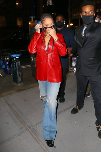 Ringing The Sexy Siren! - Rihanna&nbsp;seems to be enjoying her stay in New York City.&nbsp;Last night, the busy star was spotted heading to dinner at Nobu wearing a bright red leather blazer. The trendsetter completed the red-hot look with distressed blue jeans, black shoes, and a neck filled with several gold necklaces.&nbsp;Underneath her mask, Rih sported a bright red lipstick that perfectly accentuated her jacket. So stylish! (Photo: T.JACKSON / BACKGRID) (Photo: T.JACKSON / BACKGRID)
