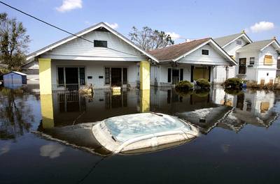 Extreme Flooding Takes Over - A car sits submerged next to a row of houses in the Edgewood neighborhood on Sept. 6, 2005, in New Orleans. Despite the dangers of toxic flood waters and disease, some tried to wait out the flooding in their neighborhoods from Hurricane Katrina.&nbsp;(Photo: Chris Hondros/Getty Images)