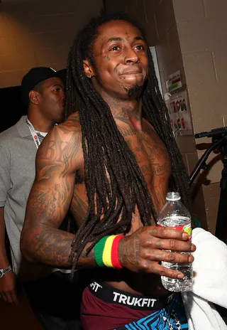 Happy Weezy - Rapper Lil' Wayne shows off his dimples and his muscular arms fresh from his performance on stage during the 2012 iHeartRadio Music Festival at the MGM Grand Garden Arena in Las Vegas.(Photo: Christopher Polk/Getty Images for Clear Channel)