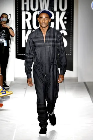 Take Us Away&nbsp; - Jumpsuits are on trend and perfect for cozying up during cuffing season.   CREDITS: • Grungy Gentleman gray printed jumpsuit • Puma black suede sneakers • Grungy Gentleman x Mitchell &amp; Ness gray/navy stripe cap (Photo: JP Yim/Getty Images)