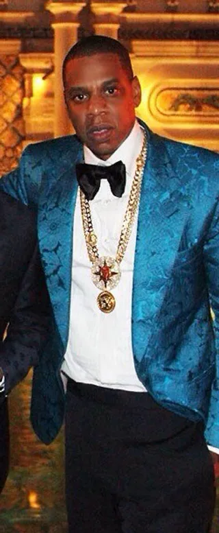 Jay Z - The rapper really knows how to make a fashion statement by forgoing a traditional black tux for this turquoise blazer and plenty of bling for Diddy's New Year's Eve party in Miami.  (Photo: Fabolous via Instagram)