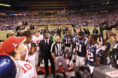 The Ceremonial Coin Toss - Referee John Parry — joined by newly anointed Hall-of-Famer Curtis Martin and team captains from the Giants and Patriots — does the honors. The Giants lost; the Pats elected to kick off. (Photo: Ezra Shaw/Getty Images)